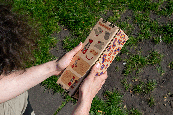 Someone holding the SABI packaging and displaying the graphics