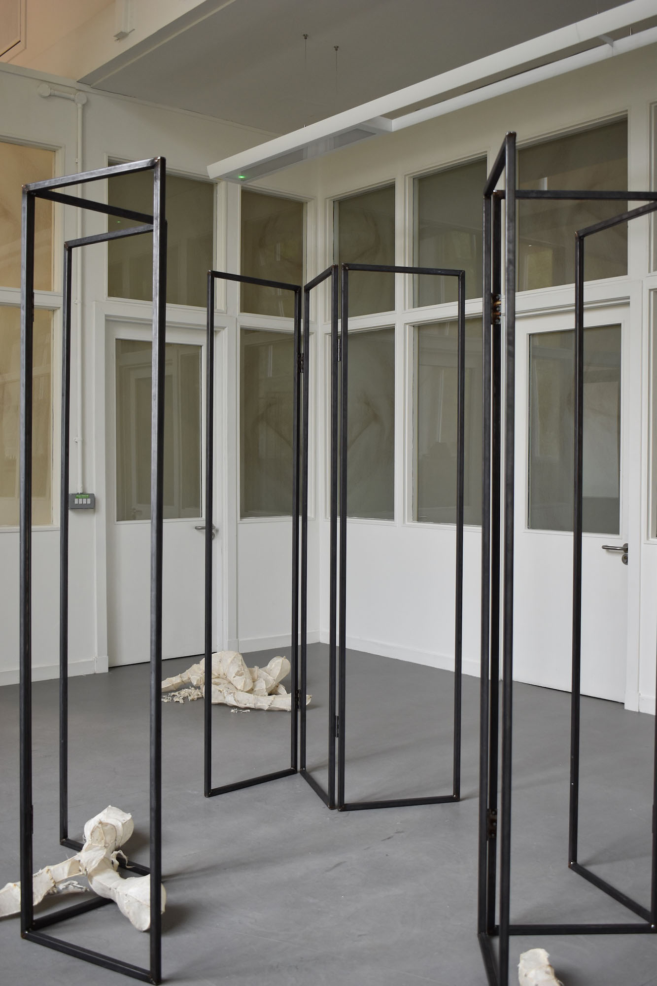 Three hollow steel dressing/privacy screens arranged in a loose circle.