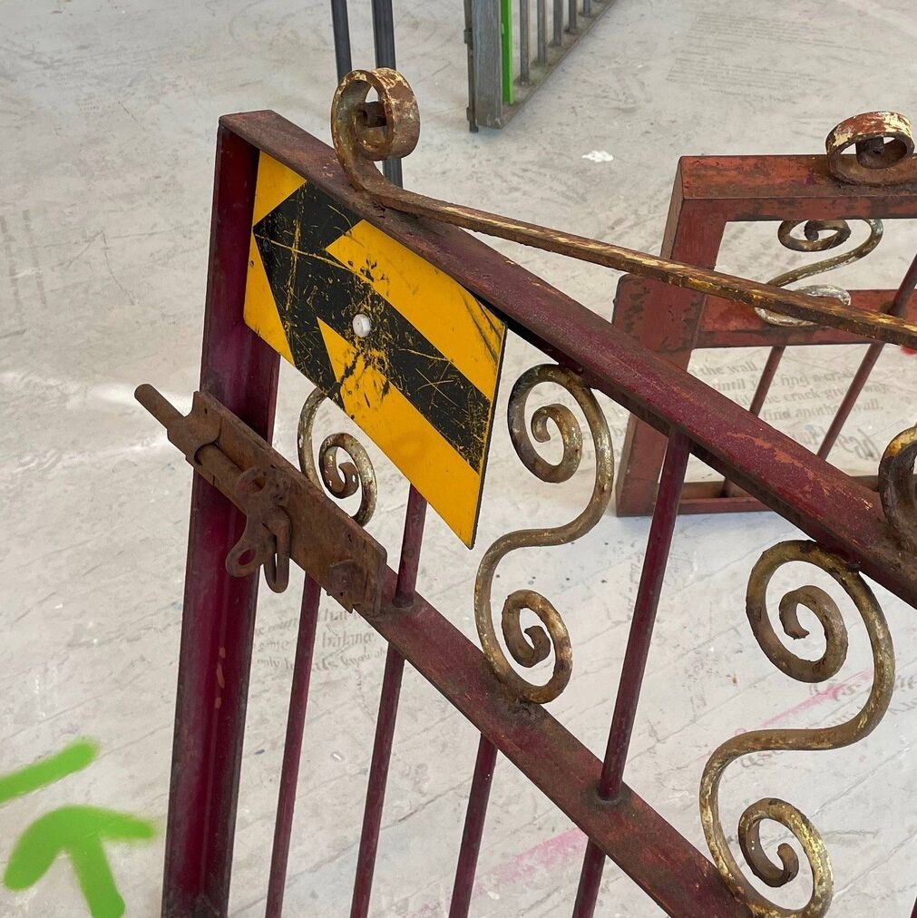 Fences, road arrow sign and construction graffiti.