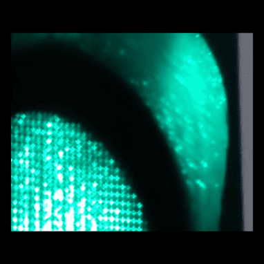 Video still from MP4 video file showing up close of green traffic lights.
