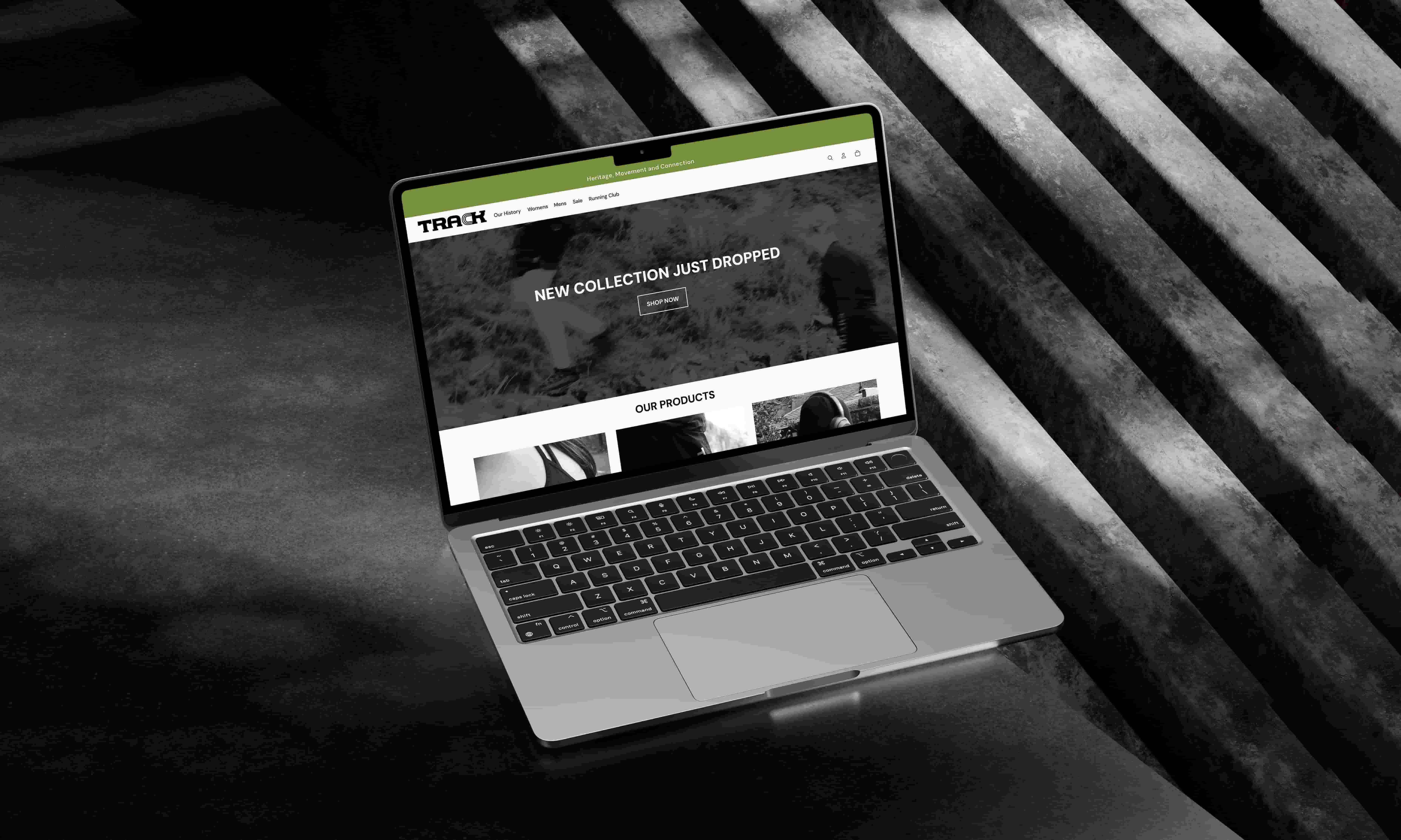     Laptop mockup displaying the TRACK website homepage. The website features monochrome running photography, a green navigation bar, product imagery, and promotional text reading ‘New Collection Just Dropped’.