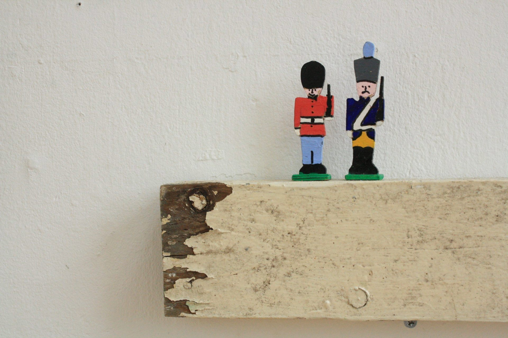 toy soldiers on a plank of wood 