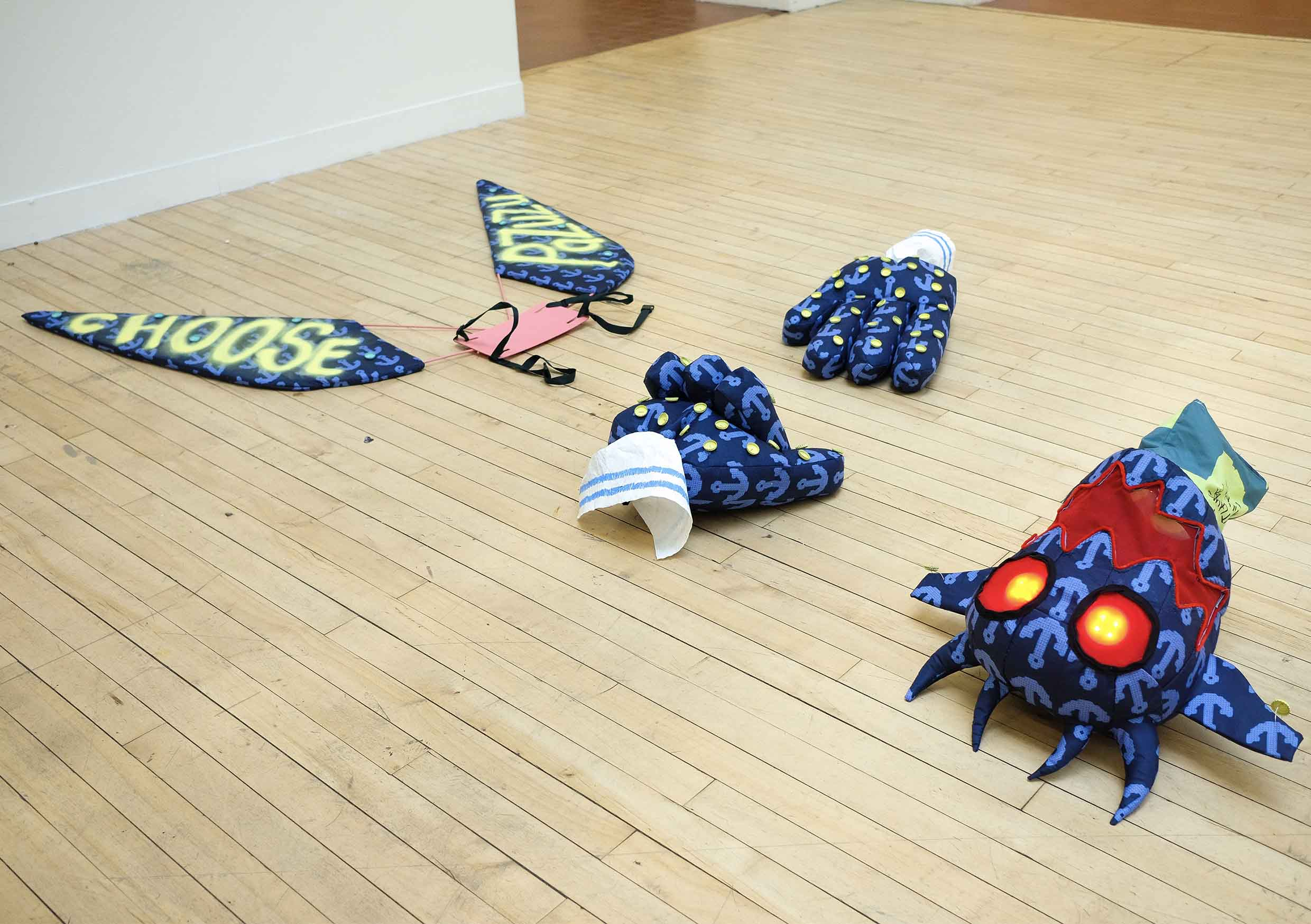 Components of Pazuzu costume placed on the floor in the sculpture court at ECA.