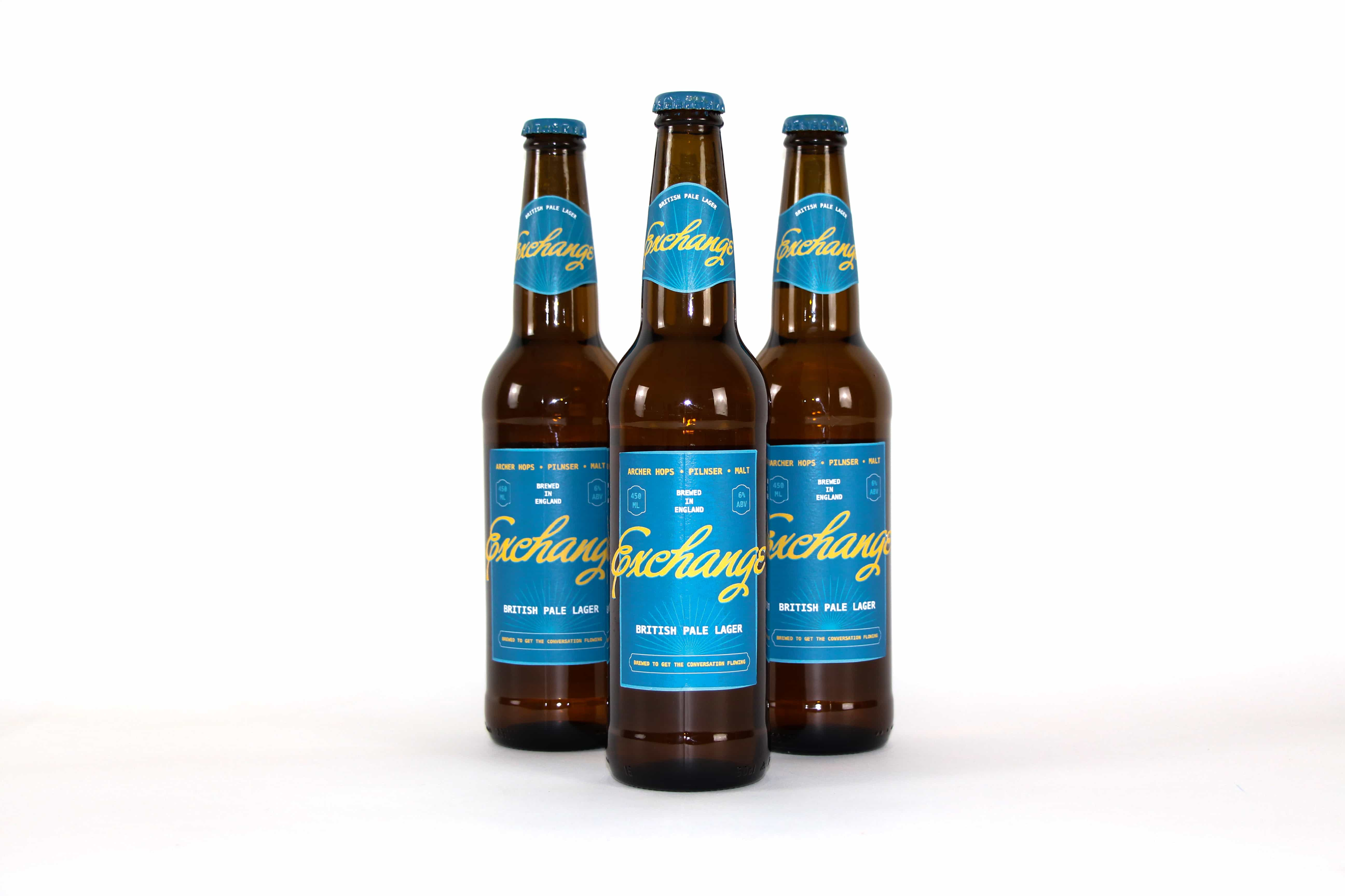     Three ‘Exchange’ British Pale Lager bottles arranged on a white background, showing the teal and yellow bottle labels.