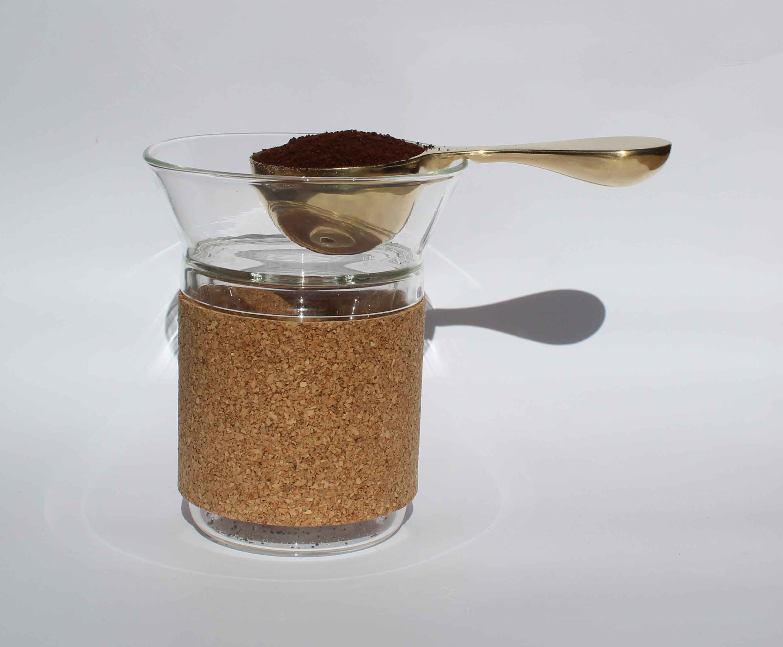 Spoon balancing on the edge of the Moment dripper's edge .