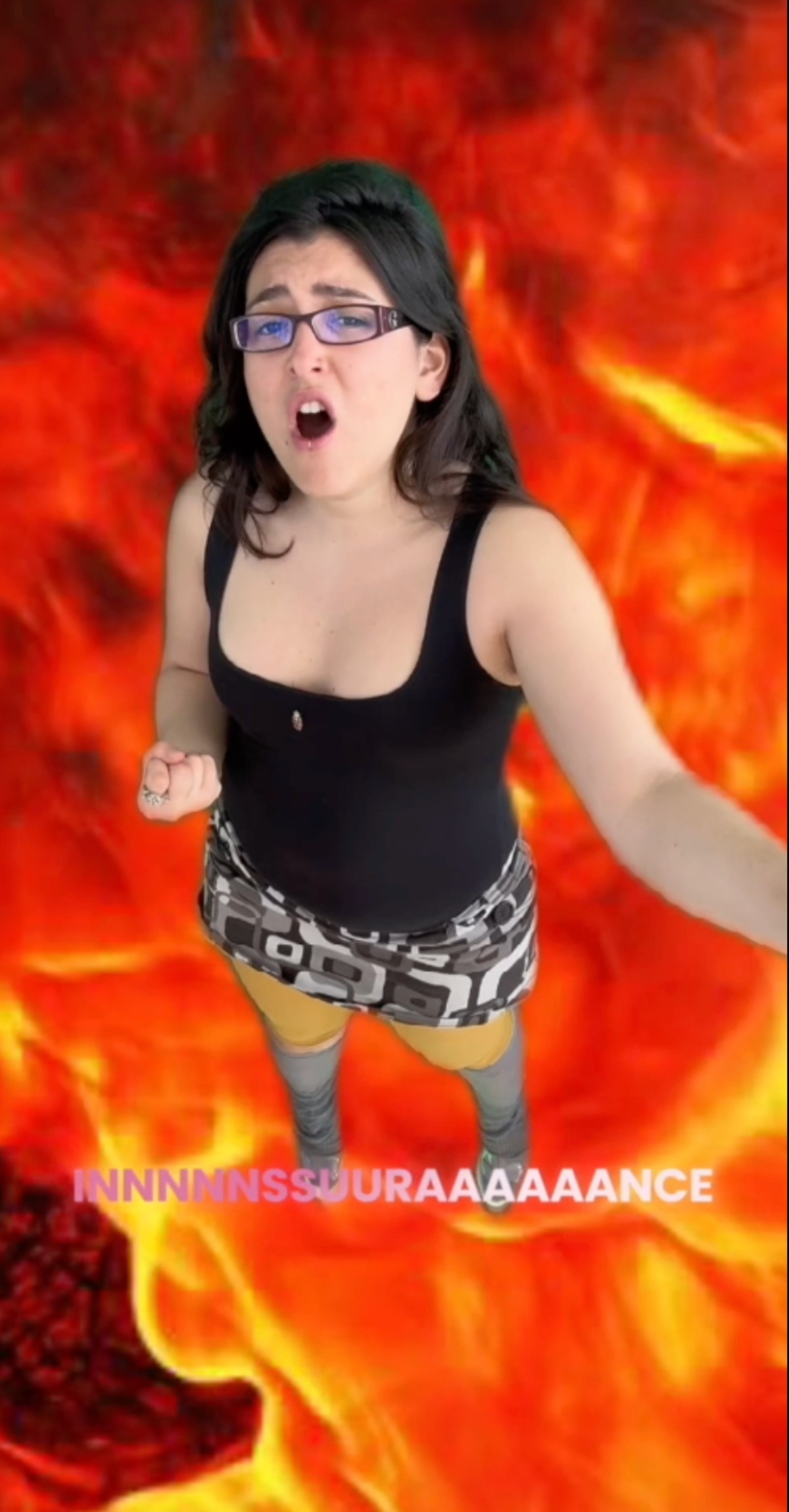 Stills from moving image work: An influencer baddie in front of fire green screen and the subtitle says Insurance