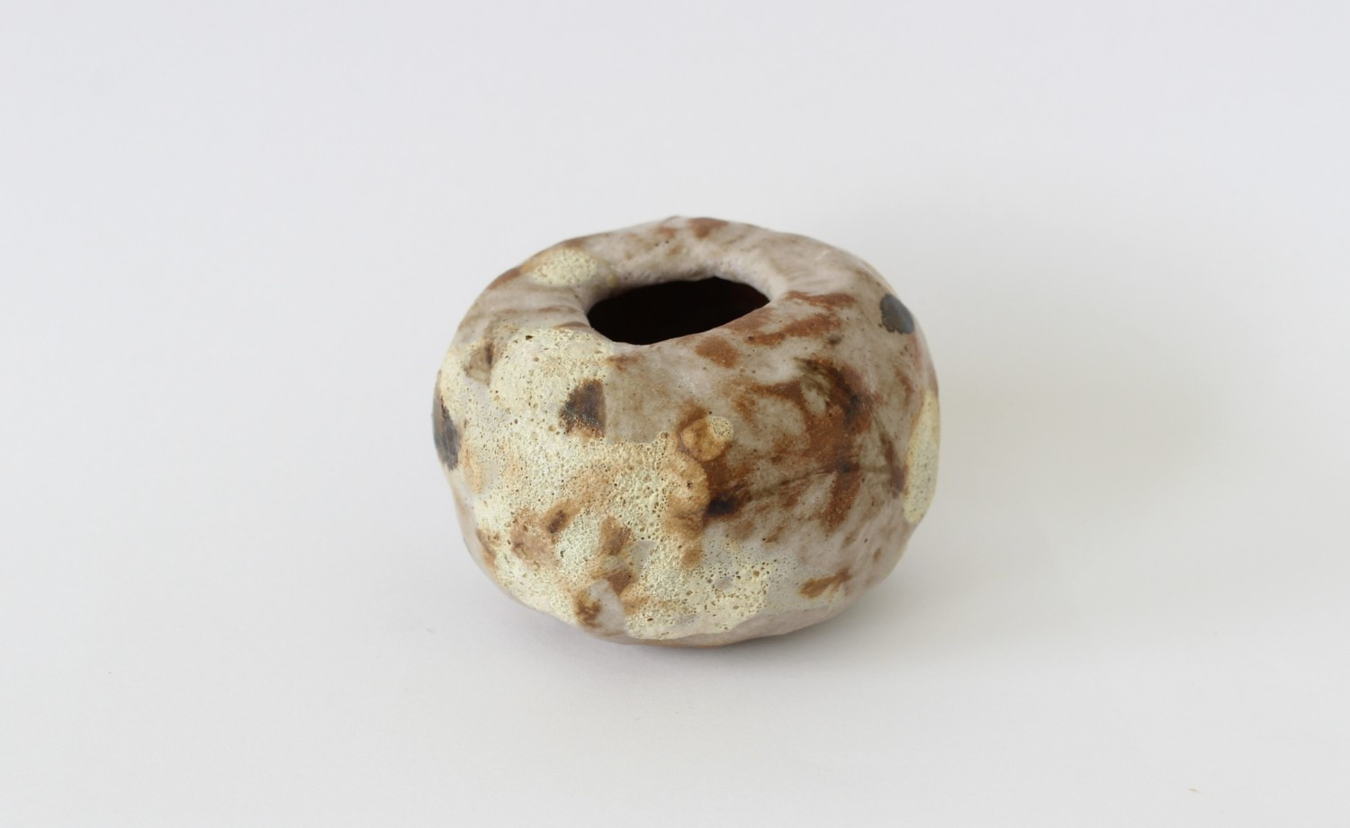 small pot with abstract textures and shapes glazed on it