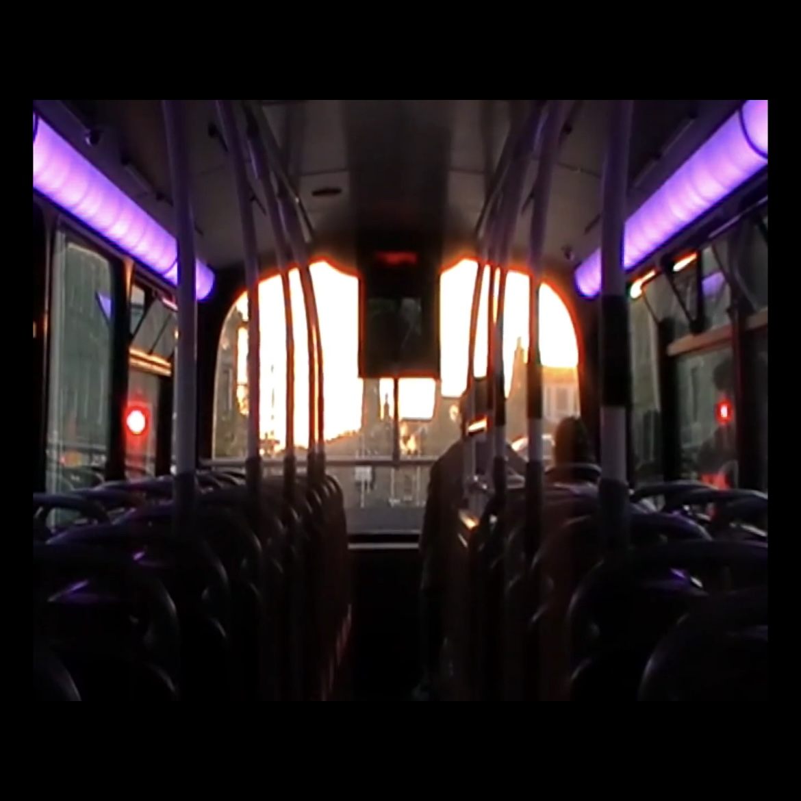Video still from MP4 video file showing bus interior before sunset.