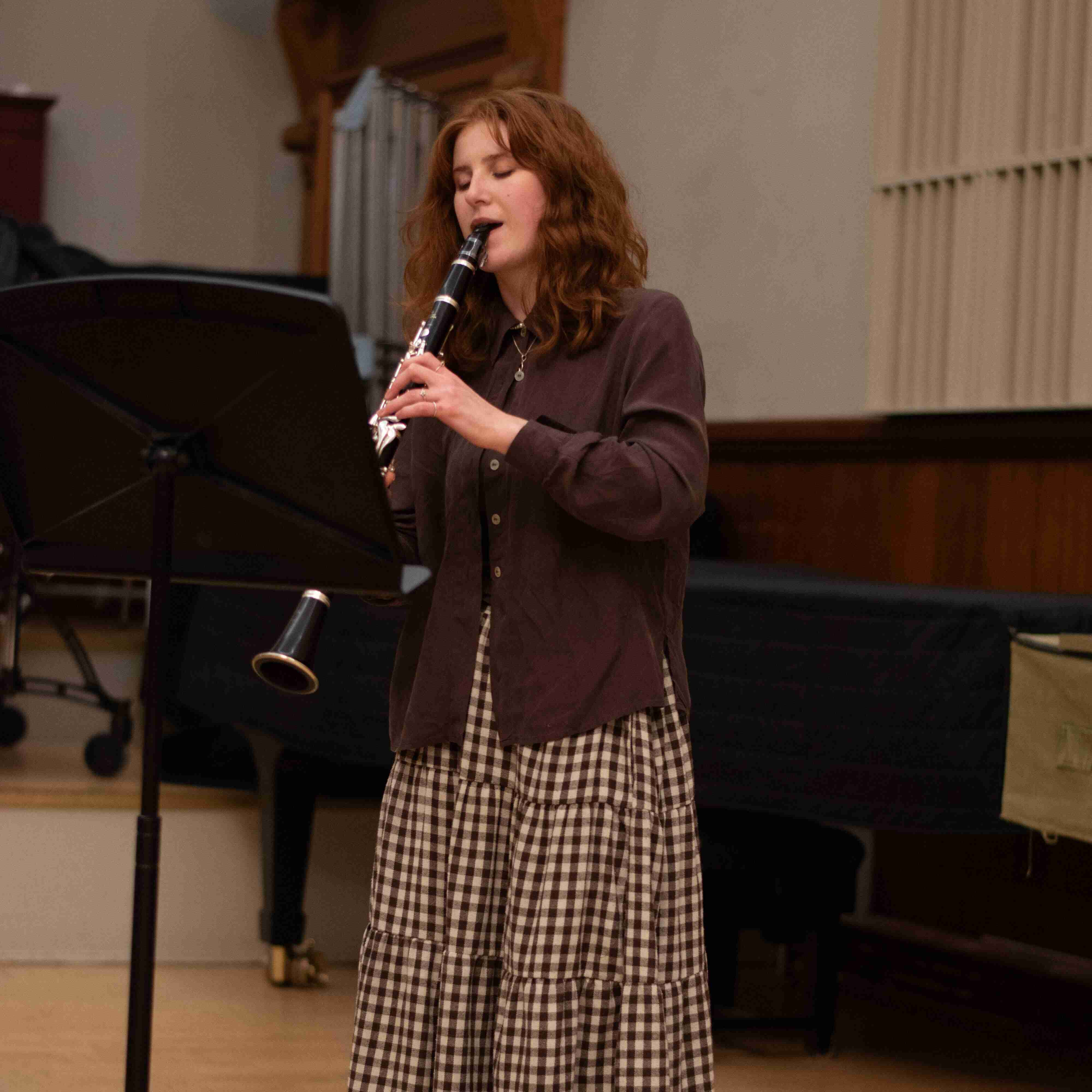 A close up shot of Katie Rawson playing solo clarinet in a concert