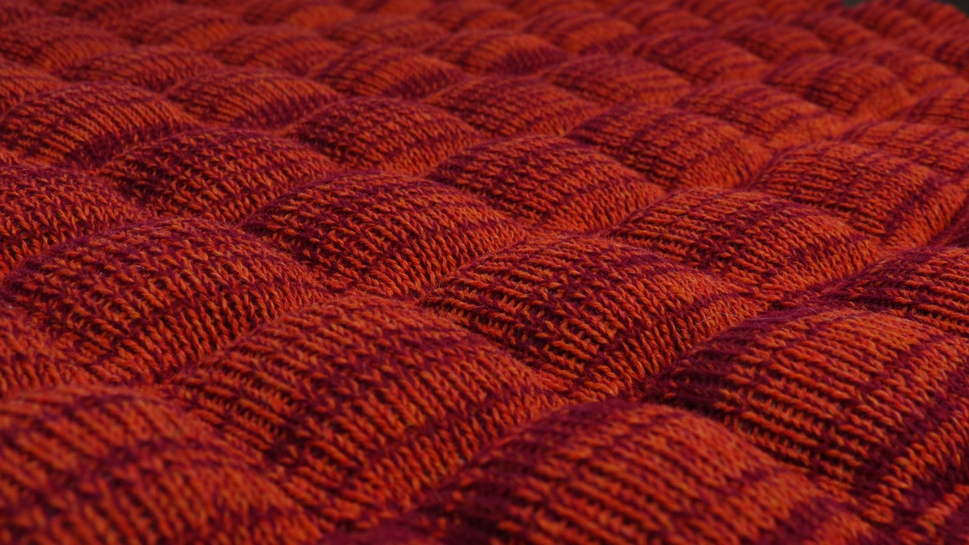 Close up of textile surface, red and orange.