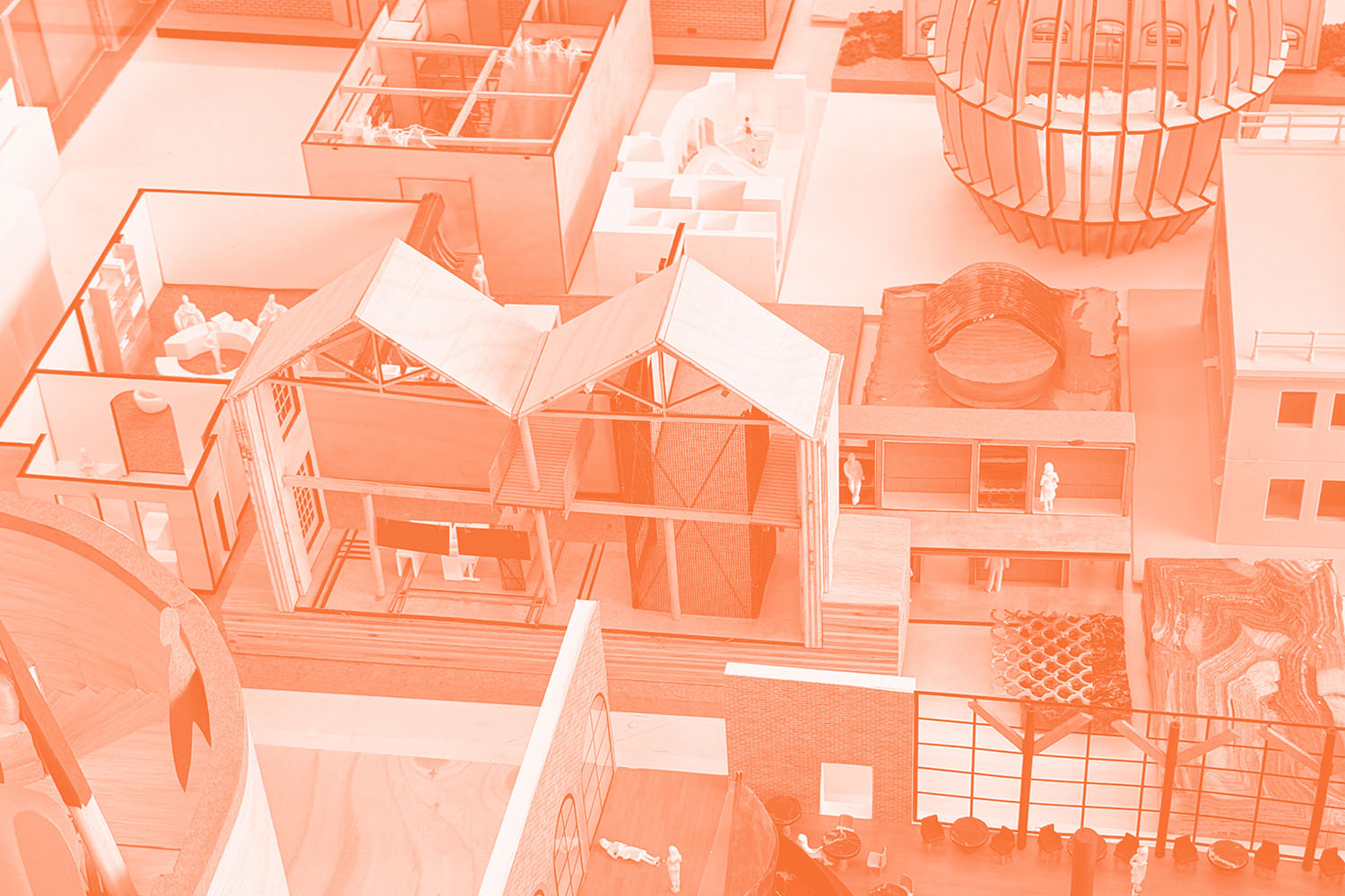 A duotone image in white and orange showing a close up of an architectural model